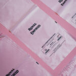 Royal Enfield sustainable packaging lifestyle image showing compostable mailer bags and eco-friendly boxes for bike accessories