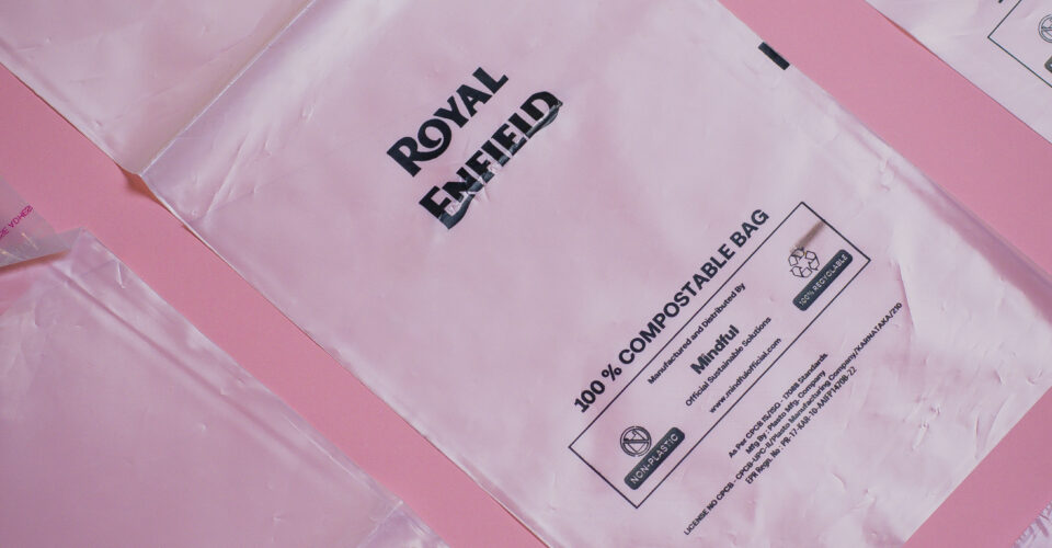 Royal Enfield sustainable packaging lifestyle image showing compostable mailer bags and eco-friendly boxes for bike accessories
